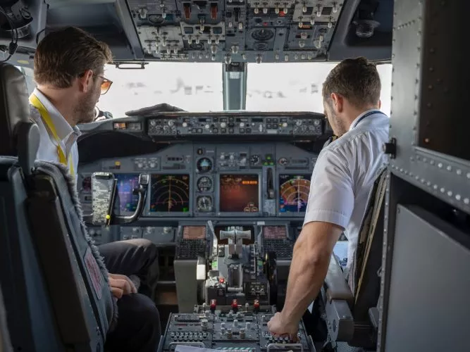 Pilots in cockpit wearing custom ear protection