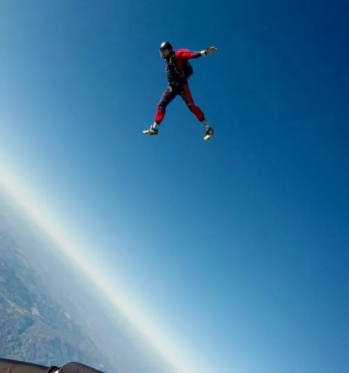 Skydiver in the air wearing custom skydiving earplugs